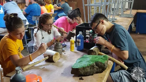 Scouts doing leatherwork at handicraft