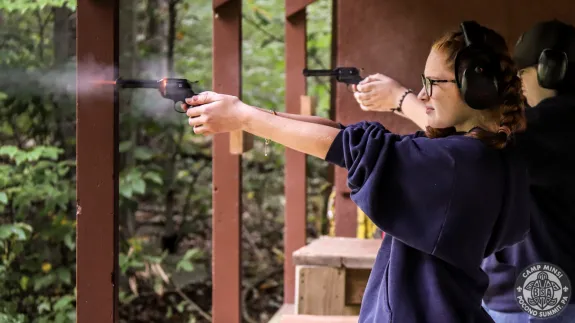 Scouts shooting pistols at range